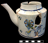 Pearlware painted underglaze  teapot.   Note damage to floral motif that probably occurred during firing. 3� rim diameter; 4.5� base diameter; 5� vessel height.